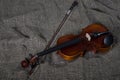 Violin, fiddlestick and bowtie, canvas background Royalty Free Stock Photo