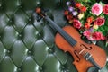 Violin and flower on luxury green leather backgrou