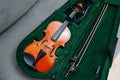 Violin gently placed in a case draped in yellow cloth. High angle Royalty Free Stock Photo