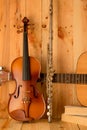 Violin,guitar and flute on wood background Royalty Free Stock Photo