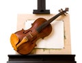 Violin laying on painting easel isolated