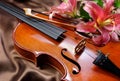 Violin and lily on a silk background Royalty Free Stock Photo