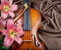 Violin and lily on a silk background copy spaces. Royalty Free Stock Photo