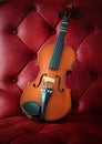Violin on luxury red leather Royalty Free Stock Photo
