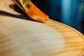 Violin maker varnishing a violin body close up. Royalty Free Stock Photo