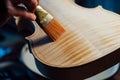 Violin maker varnishing a violin body close up. Royalty Free Stock Photo