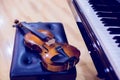 Violin and piano on wooden background Royalty Free Stock Photo