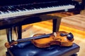 Violin and piano on wooden background