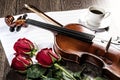 Violin, rose, coffee and music books