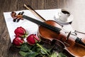 Violin, rose, coffee and music books