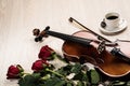 Violin, rose, coffee and music books
