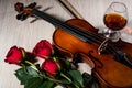 Violin, rose, glass of champagne and music books