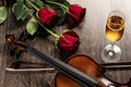 Violin, rose, glass of champagne and music books