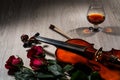 Violin, rose, glass of champagne and music books