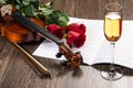 Violin, rose, glass of champagne and music books Royalty Free Stock Photo