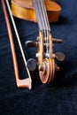 Violin scroll and bow on black velvet Royalty Free Stock Photo