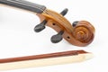 Violin Scroll with Tuning Pegs and Fiddle Bow Royalty Free Stock Photo