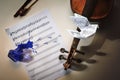 Violin and a sheet of music with started handwritten song All the birds are already here, overturned ink jar, bird footprints and Royalty Free Stock Photo