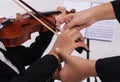 The violin teacher hands is teaching the violin student,by touch student hand for using bow to play on string Royalty Free Stock Photo