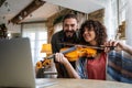 Violin teacher helping a woman student at home Royalty Free Stock Photo