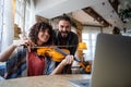 Violin teacher helping a woman student at home Royalty Free Stock Photo