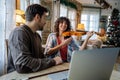 Violin teacher helping a woman student at home Royalty Free Stock Photo