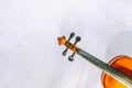 Violin volute and fingerboard on a white marble background. Selective focus Royalty Free Stock Photo