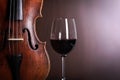 Violin waist detail with glass of wine Royalty Free Stock Photo