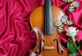 Violin, white rose and colorful tropical butterflies on red silk background. Idea leuconoe. Rice paper butterfly.