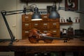 Violin on a wooden table under the lamps after the luthiery on the workshop Royalty Free Stock Photo