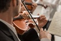 Violinist performing on stage with orchestra Royalty Free Stock Photo