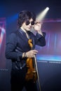 Violinist a player with a violin instrument in his hands. Artist of classical music or alternative music direction. Concept of Royalty Free Stock Photo