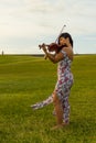 Violinist playing on the grass Royalty Free Stock Photo