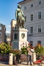 Violinist plays in front of the statue of Wolfgang Amadeus Mozart in Salzburg, Austria Royalty Free Stock Photo