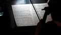 violinist reading scales in the dark