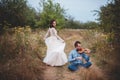 Violinist and woman in white dress , young man plays on the violin the background nature Royalty Free Stock Photo