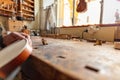 luthier carving the shape of the outside of the front of a violin with gouge Royalty Free Stock Photo