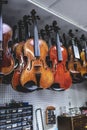 violins are handing in a shop ready for finishing Royalty Free Stock Photo