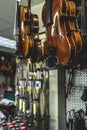 violins are handing in a shop ready for finishing Royalty Free Stock Photo