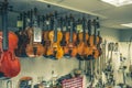 violins are handing in a shop ready for finishing Royalty Free Stock Photo