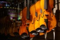 Violins on display with reflection of street party Royalty Free Stock Photo