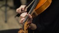 Violoncellist playing in the orchestra on stage conservatory. Close up