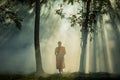 Vipassana meditation monk walks in a quiet forest.