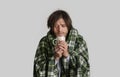 Viral disease. Man with blanket and cup Royalty Free Stock Photo