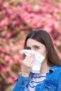 Viral infection, young girl coughs in a tissue paper