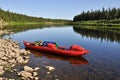 Virgin Komi forests, the red boat on the river.