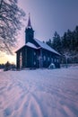 Virgin Mary Church in Grun, Beskid Mountains. Beautiful small wooden church. Winter fairytale picture. Sky glows on the Royalty Free Stock Photo