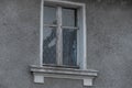 Virgin Mary figurine in an old, dusty window.