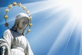 Virgin Mary. Fragment of ancient statue against blue sky Royalty Free Stock Photo