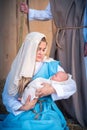 Virgin mary holding Jesus baby in a traditional nativity scene